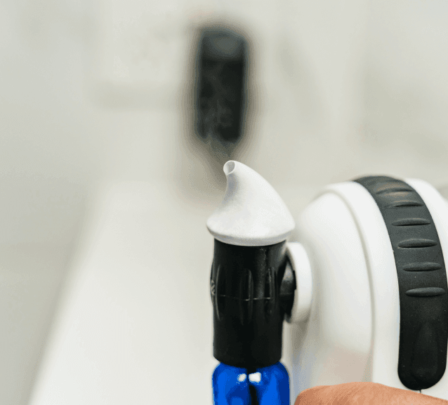 Close-up of a cleaning brush applying foam during mould removal