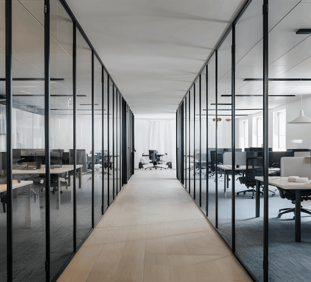 Clean contemporary office interior with glass walls and desks